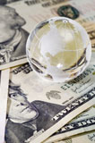 globe sitting on money